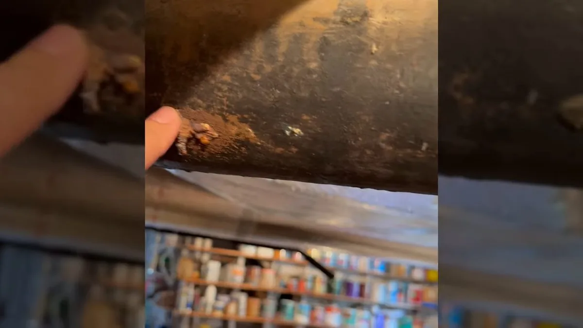 Aging cast iron drain pipe visible below a home during plumbing inspection in Flintridge
