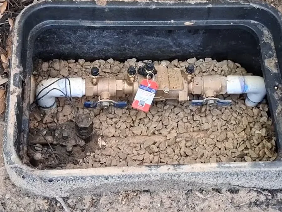 Backflow preventer assembly installed inside an outdoor valve box