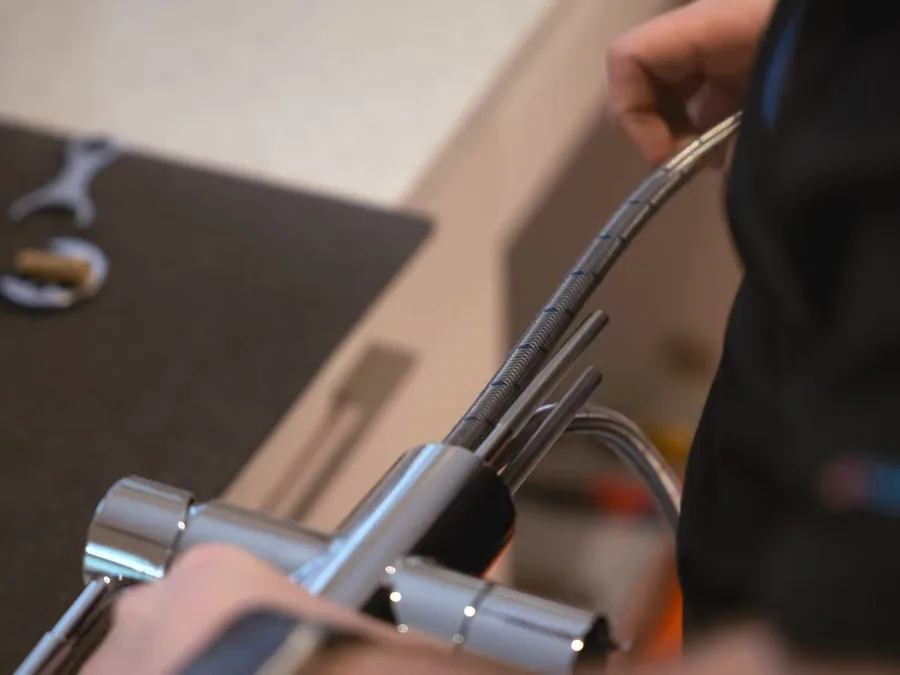 Faucet cartridge service using a hand tool on a bathroom fixture