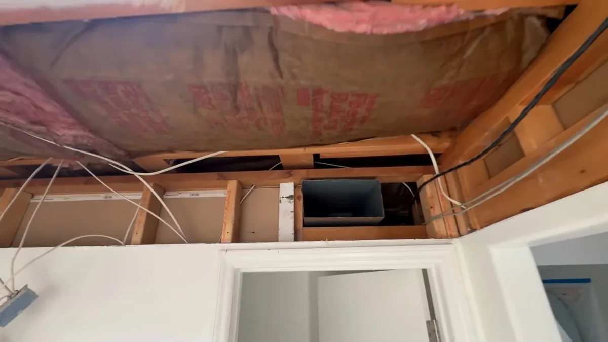 Bathroom renovation ceiling and wall framing exposed before finish work