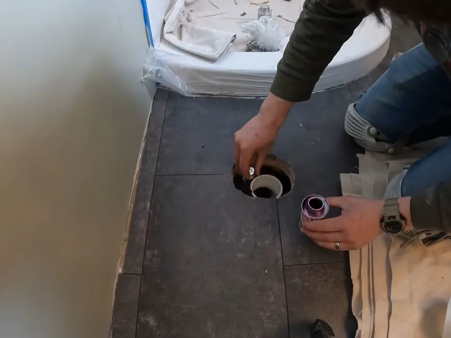 Bathroom sink rough-in work during a remodel with drain and supply connections exposed