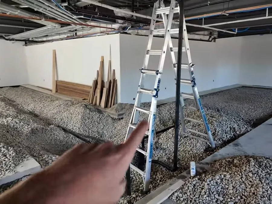 Commercial plumbing drain layout installed across an open concrete floor