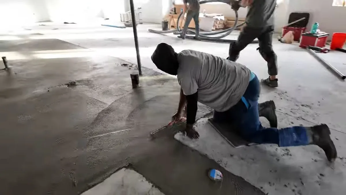 Commercial plumbing rough-in work across an open floor near a technical facility property