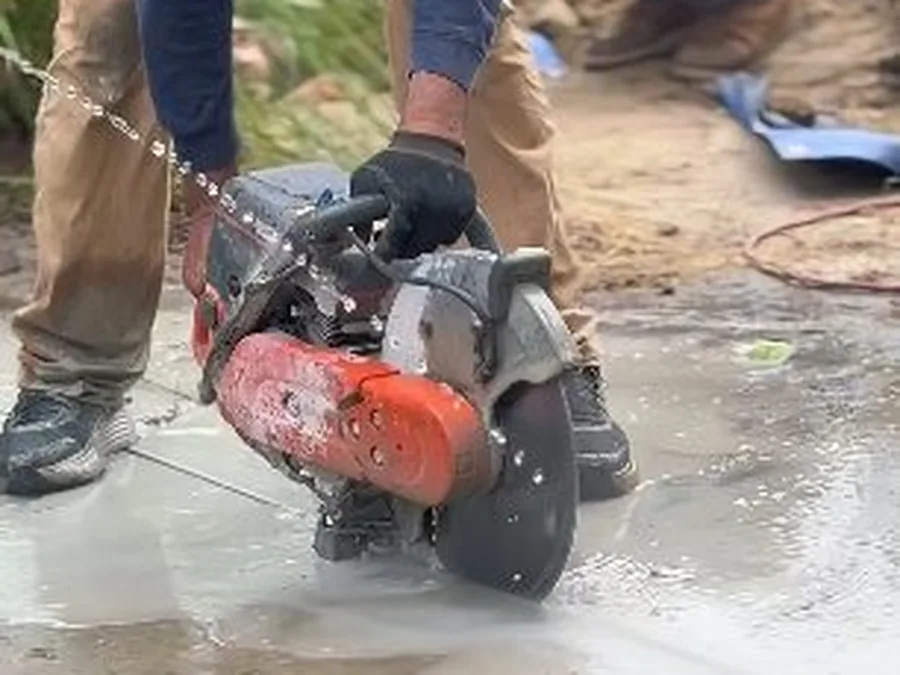 Concrete saw cutting an access area during slab leak repair