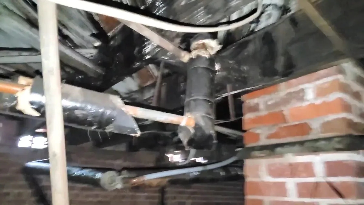 Crawlspace plumbing lines under a foothill home during leak investigation
