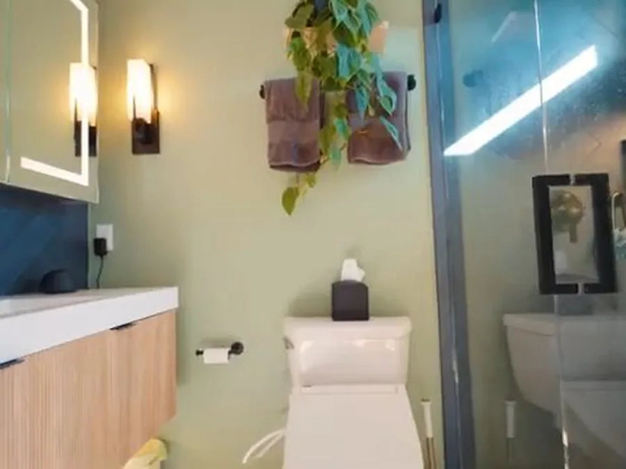 Finished bathroom with vanity and toilet after plumbing remodel work
