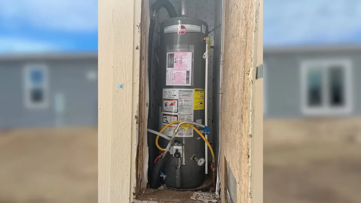 Water heater installed in a garage closet during an estate home plumbing inspection