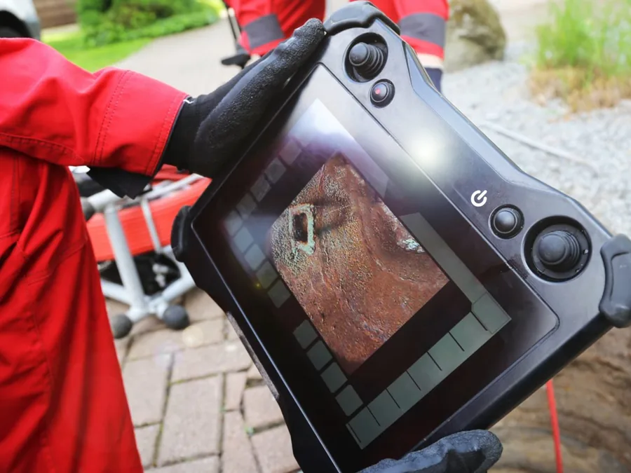 Technician using inspection equipment during pool leak detection