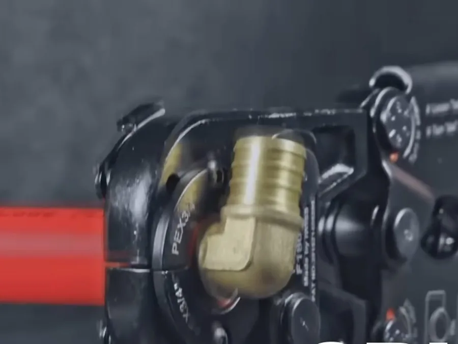 Press tool securing a PEX pipe fitting during repiping