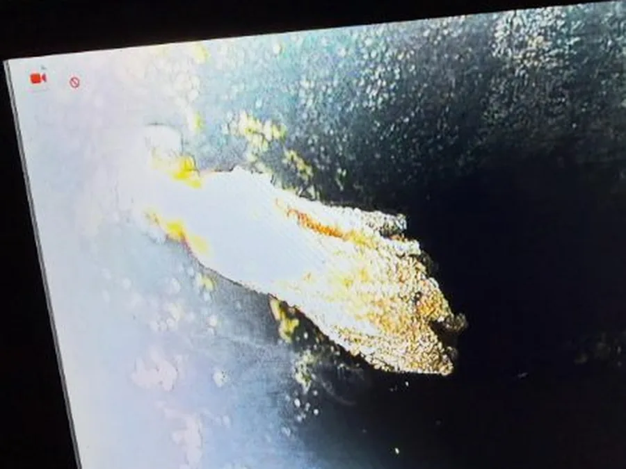 Sewer camera screen showing a pipe obstruction during lateral inspection