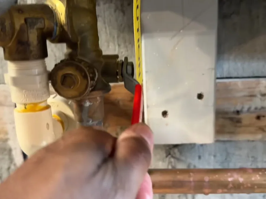Tankless water heater descaling pump and bucket connected during maintenance