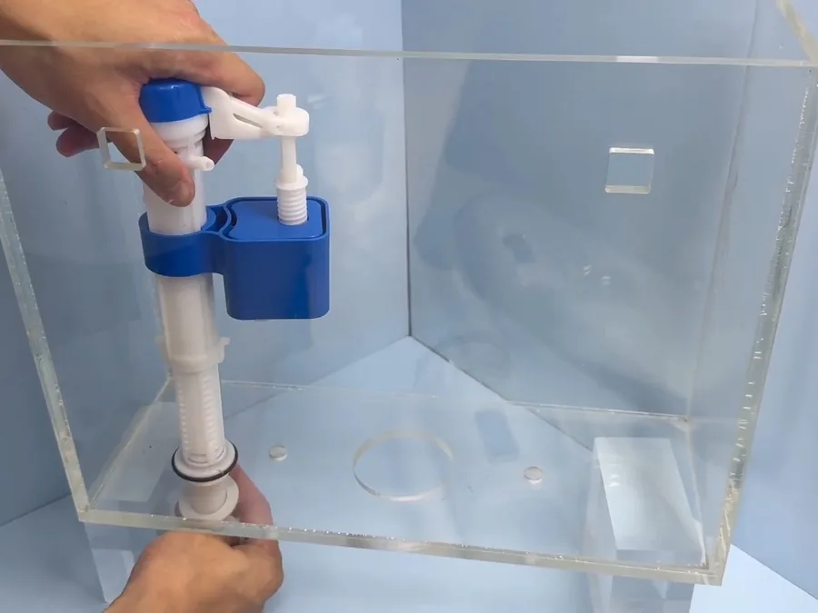 Toilet fill valve being adjusted inside an open tank