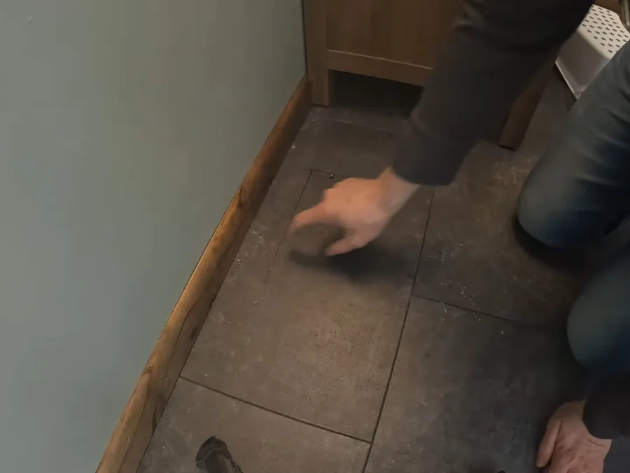 Toilet flange area being prepared in a bathroom floor during remodeling