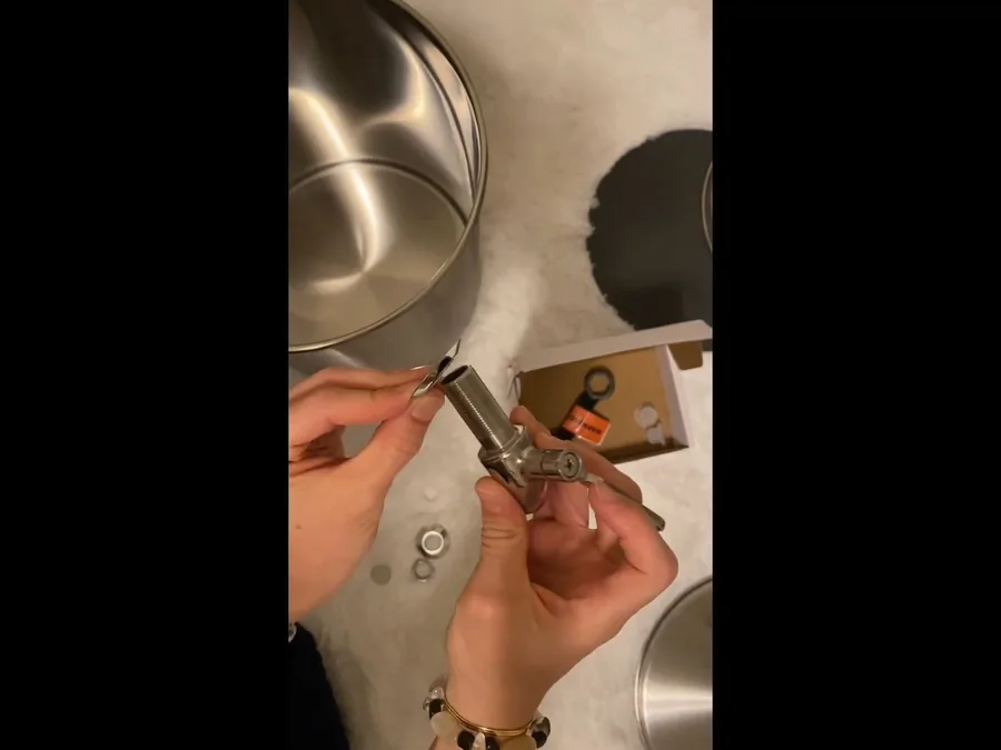 Hand adjusting a gas water heater control area during gas line service
