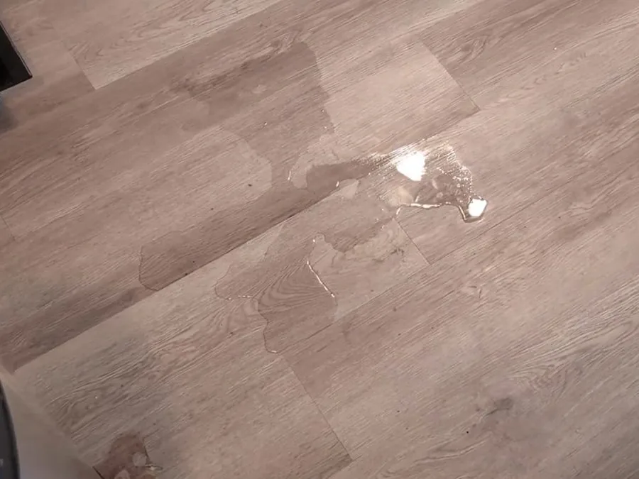 Wet flooring from an active plumbing leak inside a home
