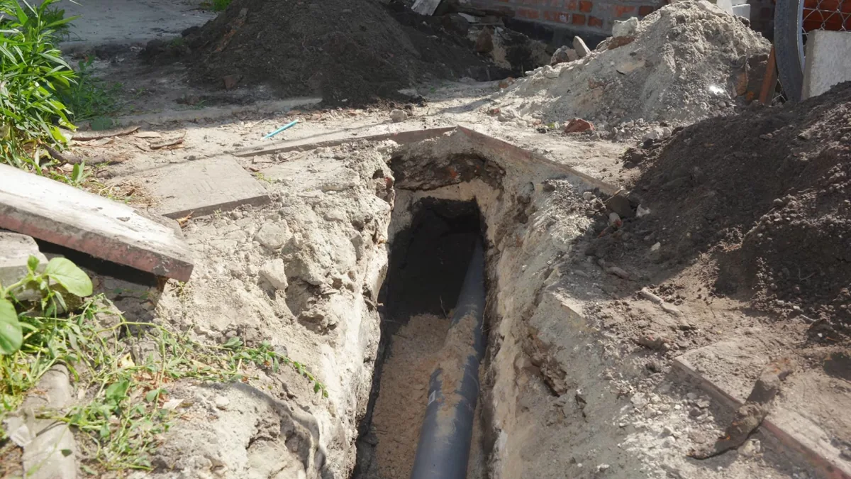 Yard trench exposing sewer access during plumbing replacement in Sunland